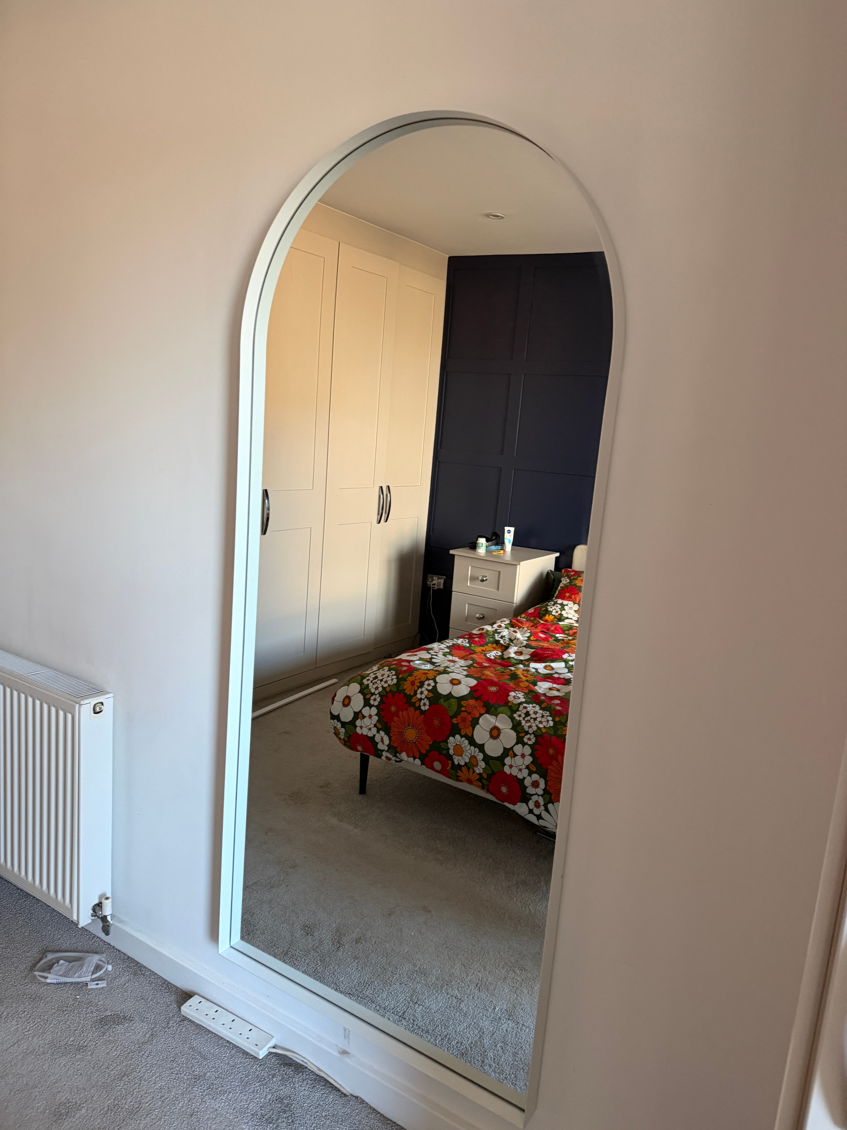 Large arch mirror securely wall-mounted
