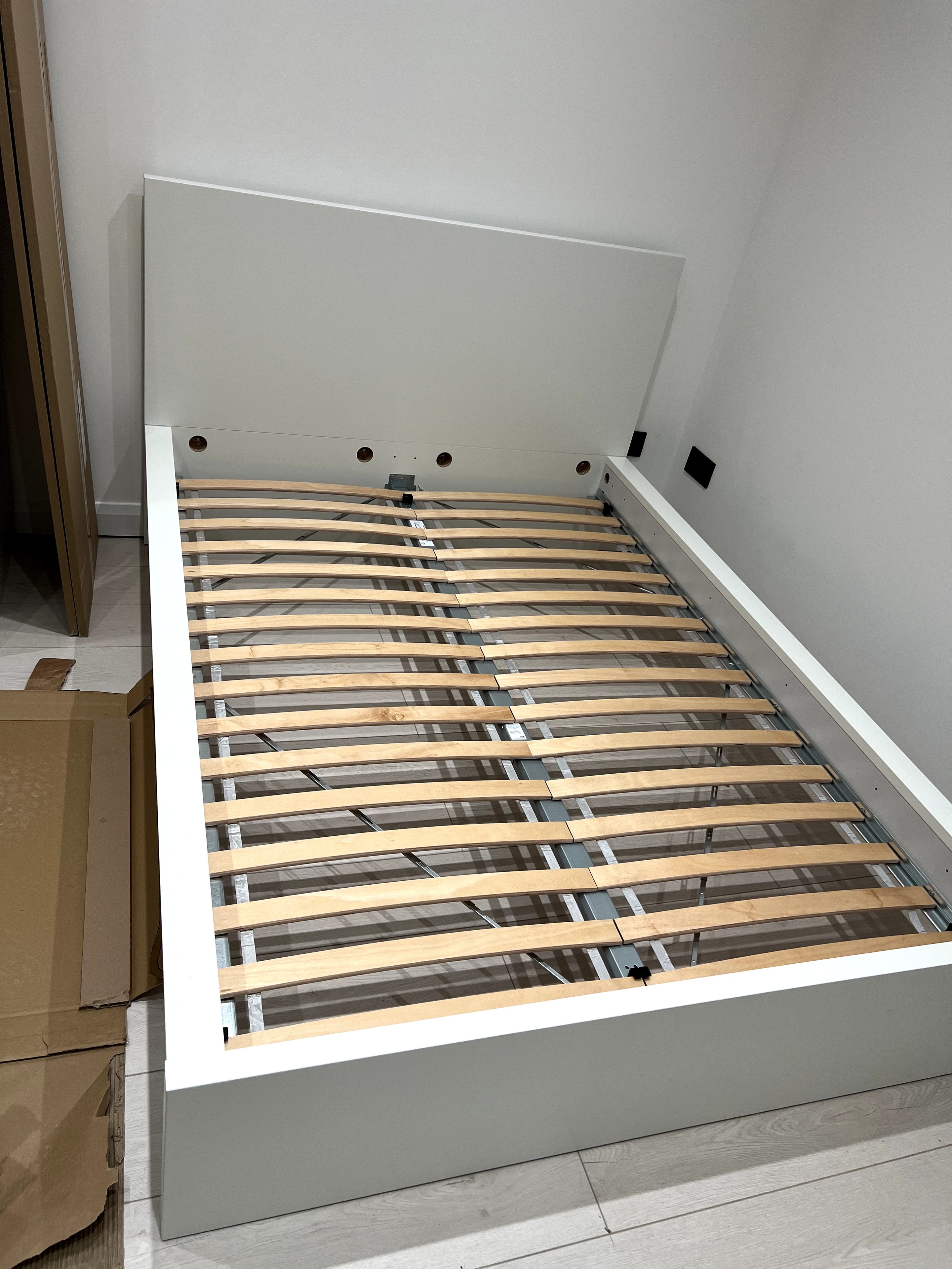 White double bed frame with wooden slats assembled