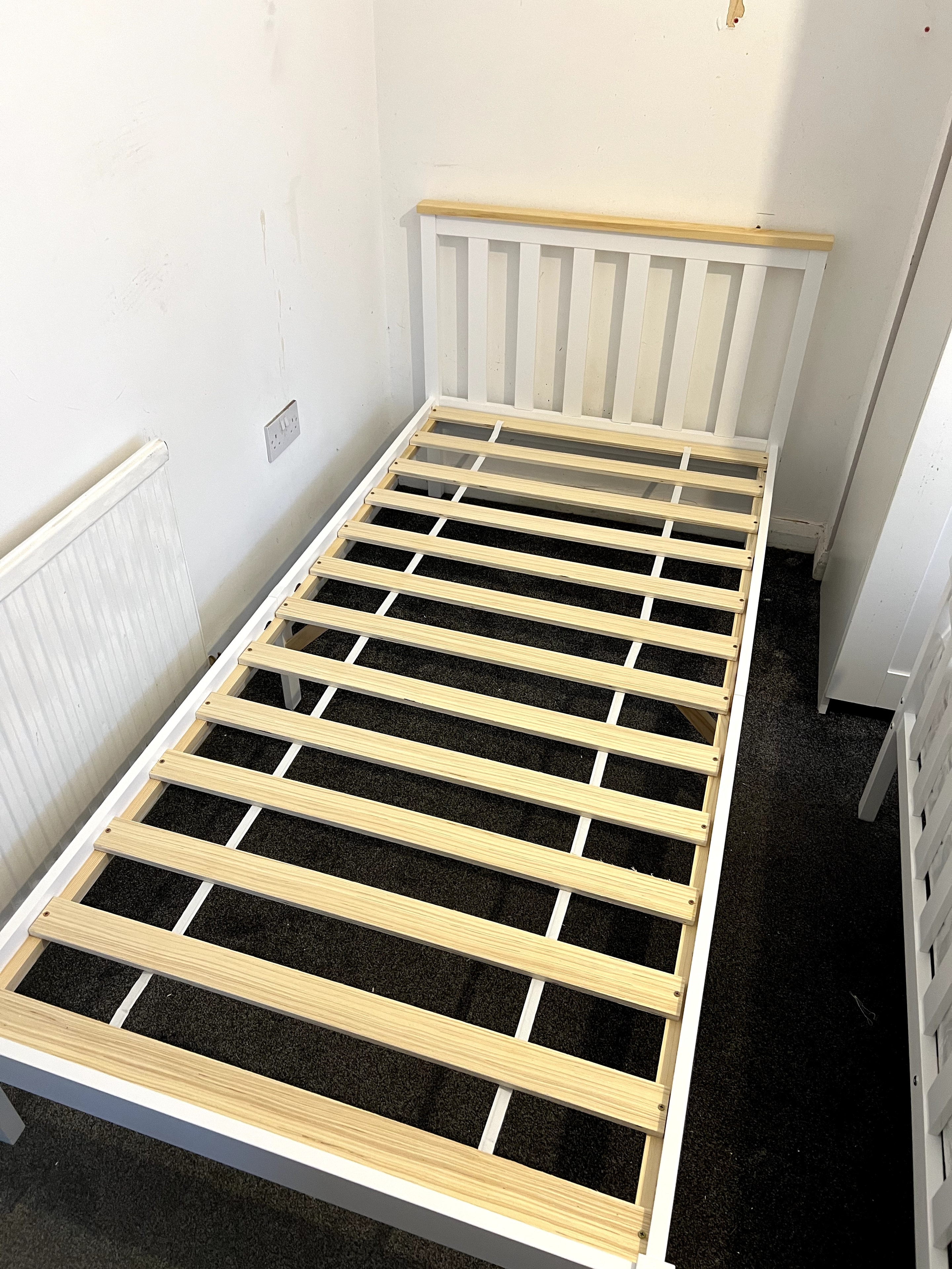 White double bed frame with slatted headboard assembled