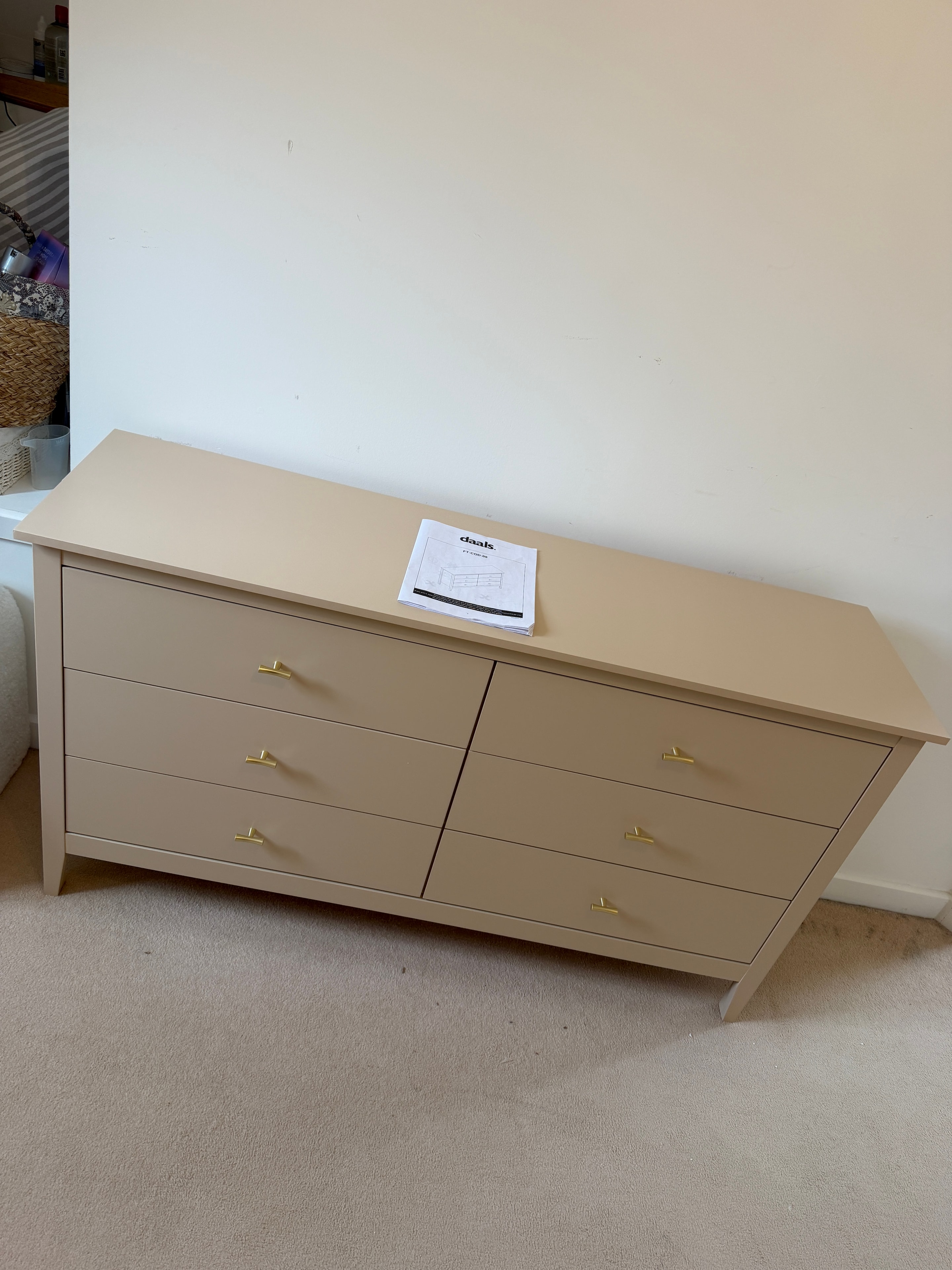 Tall storage cabinet in tan finish assembled
