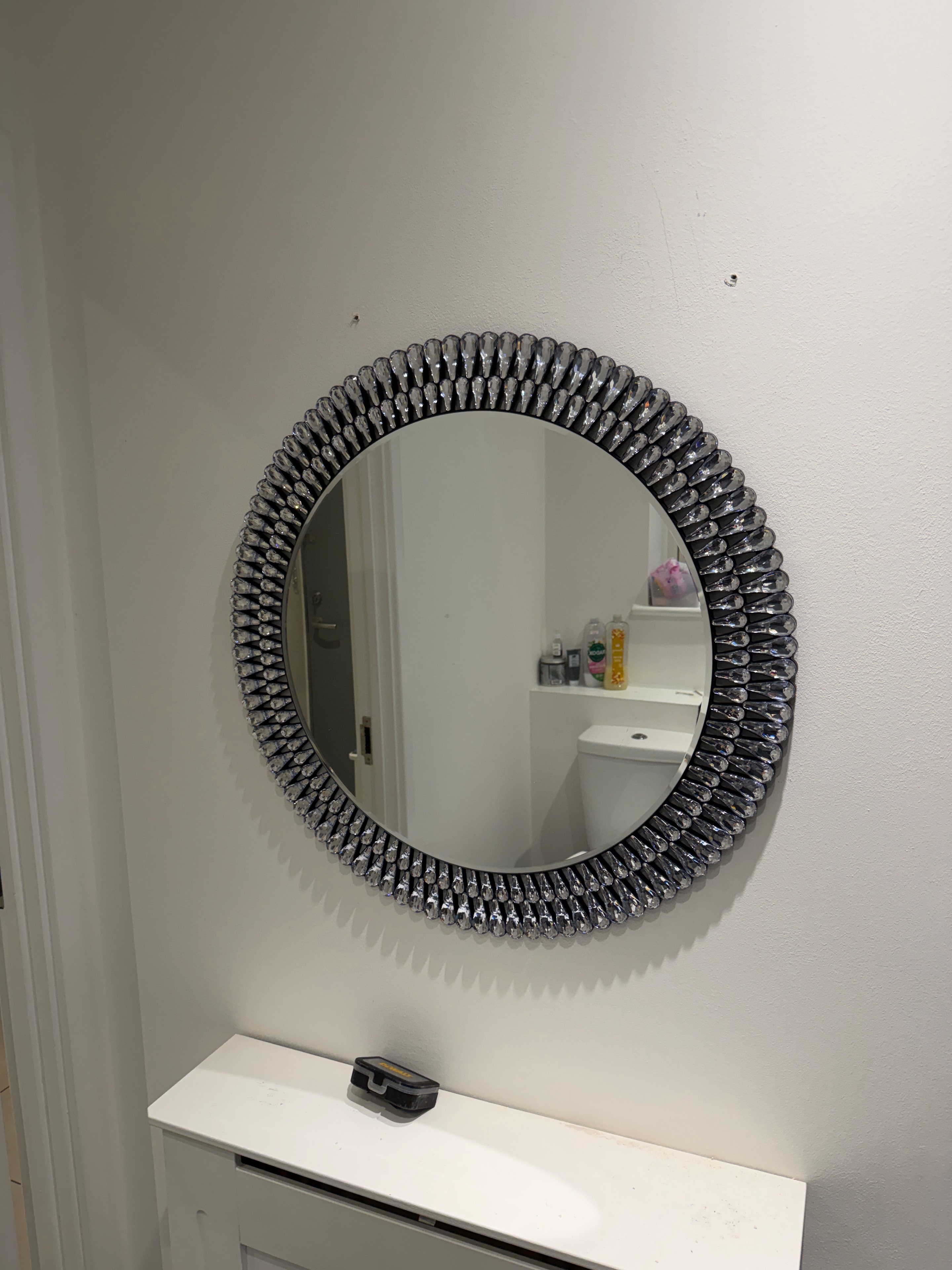 Decorative mirror hung and centred on wall