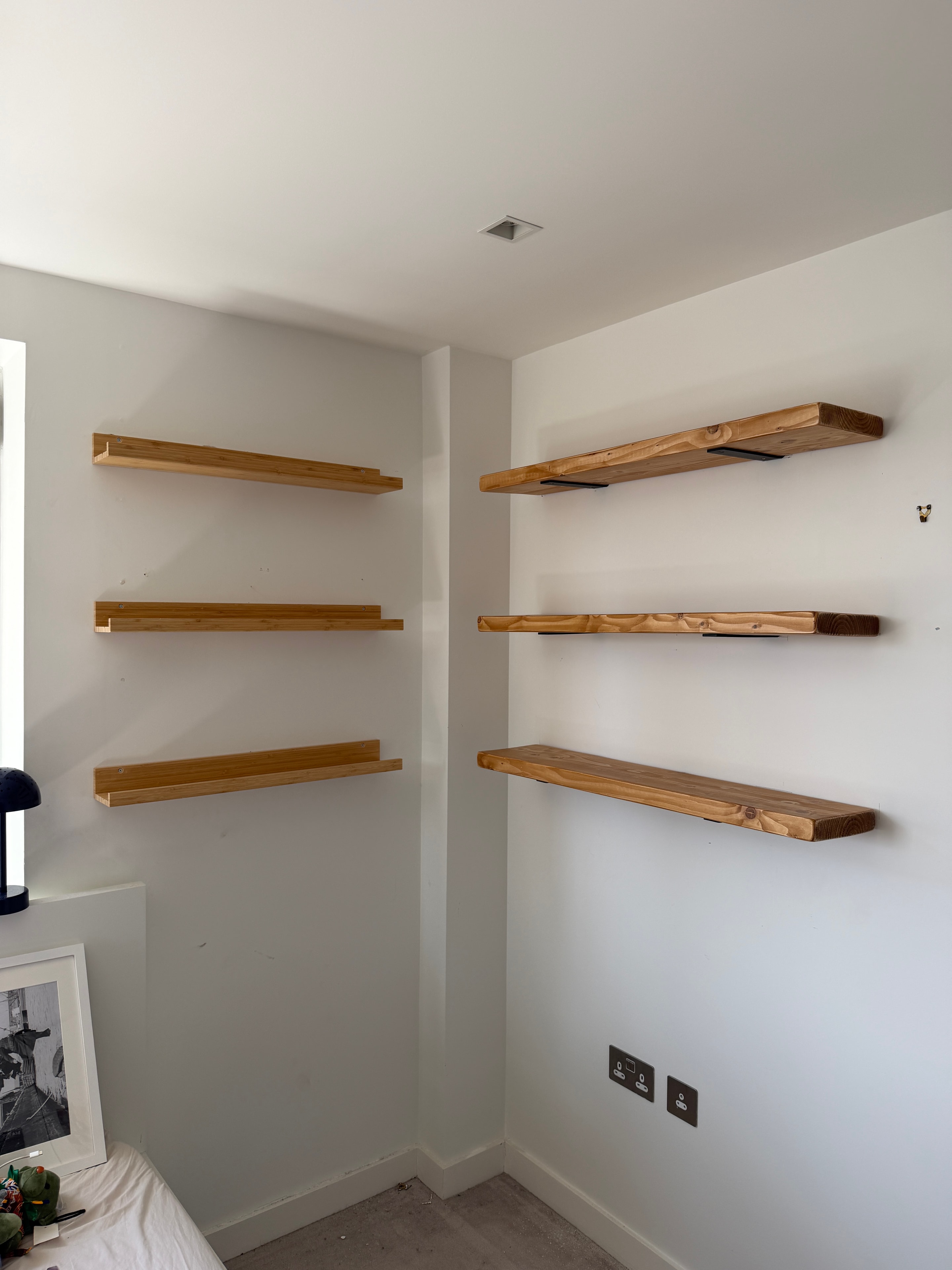 Row of floating wooden wall shelves installed and level