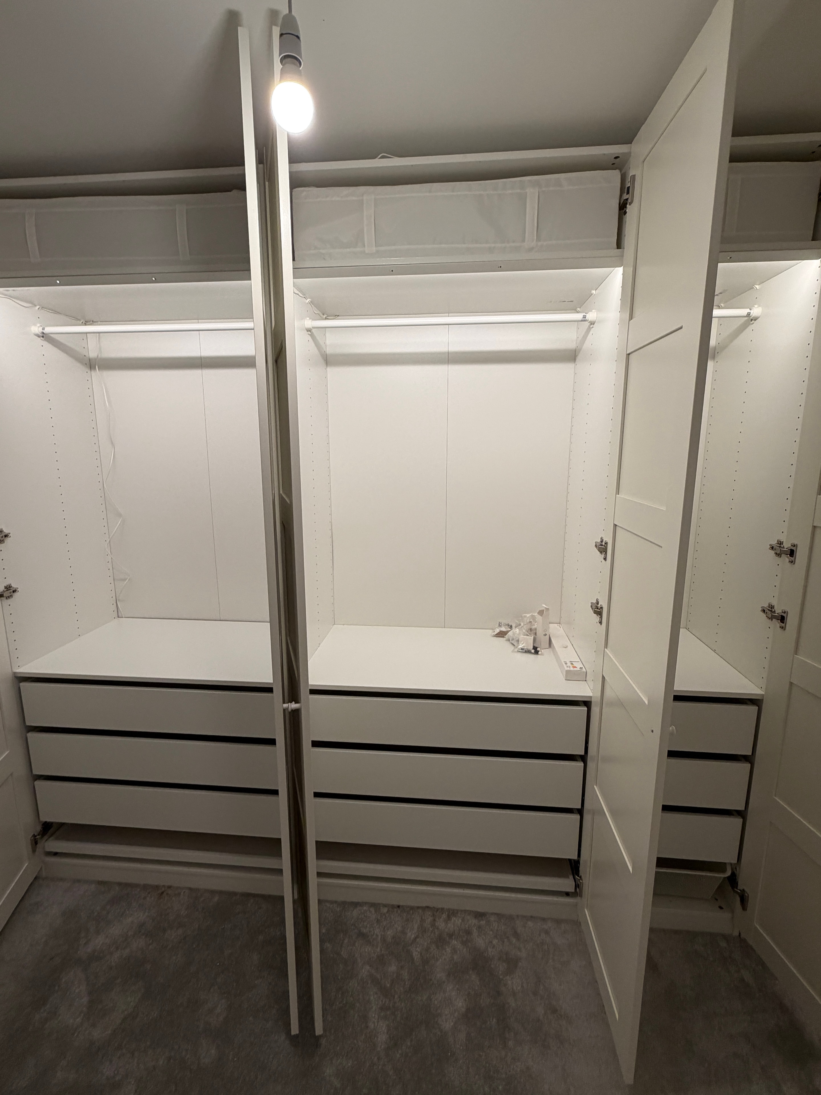 Large PAX wardrobe interior with double hanging rail and LED light assembled