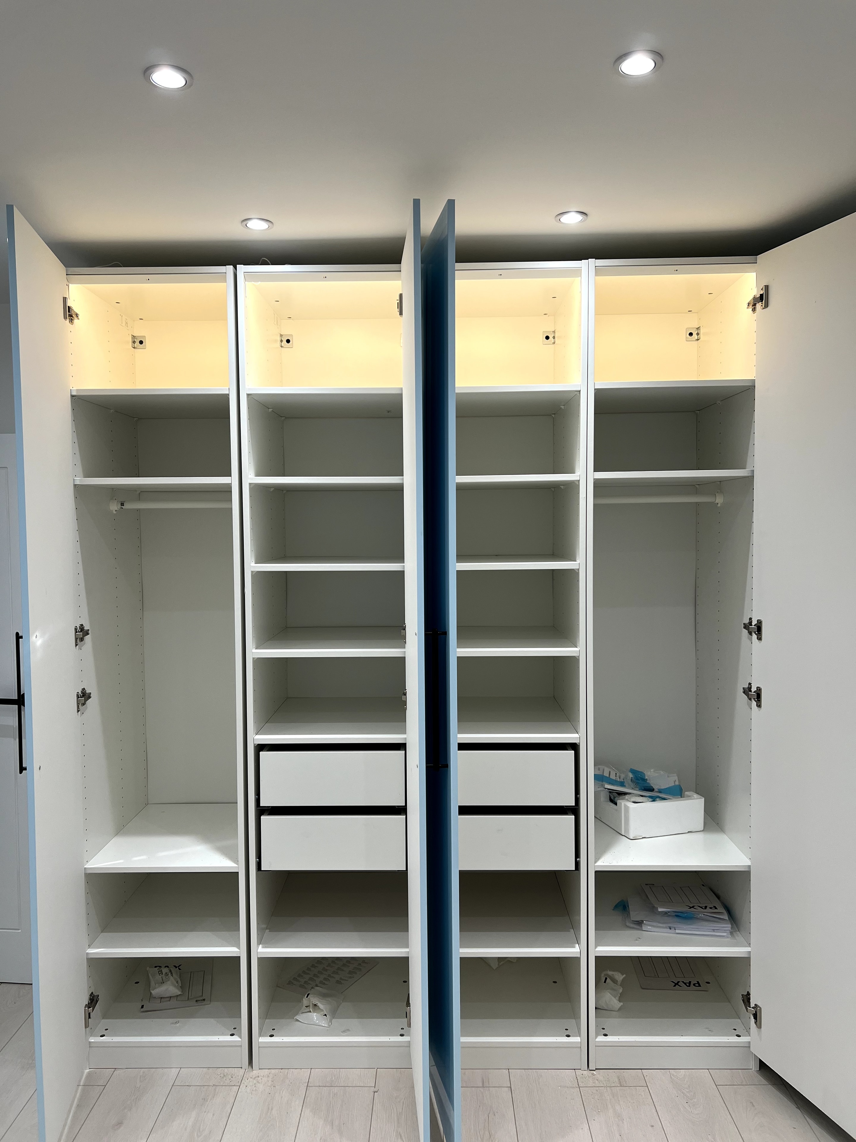 Open PAX wardrobe showing interior shelving and hanging rail